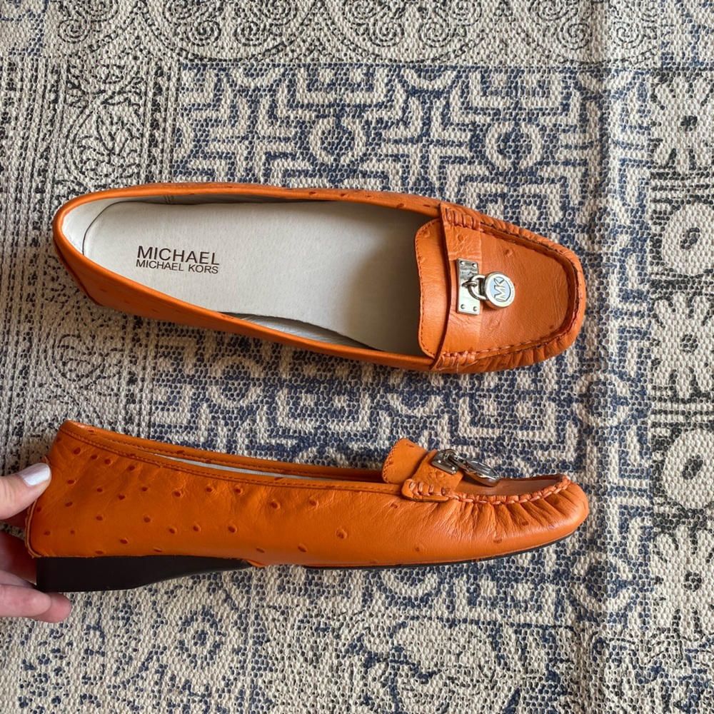 Michael Kors orange ostrich loafers.